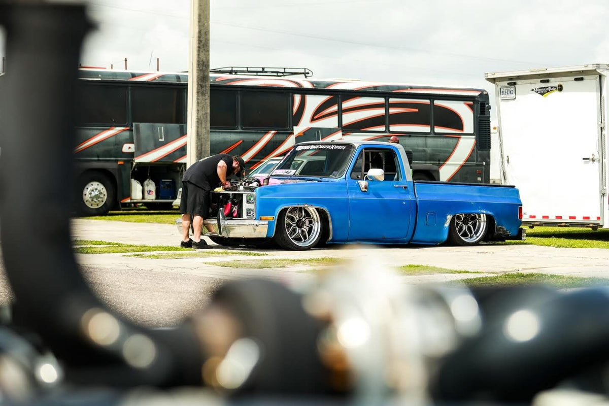 Two blue C10s parked together in the paddock